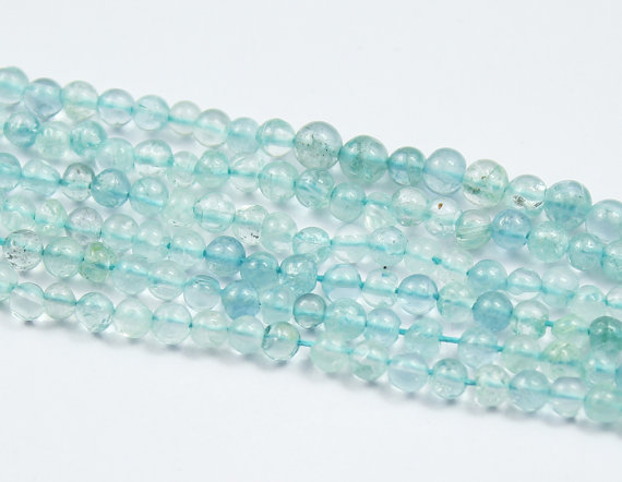 Natural Blue Aquamarine Smooth Round Ball Beads Strand Length 14 Inches and Size 3.5mm approx.These are 100% genuine aquamarine beads. Aquamarine is blue color variety of Beryl Gemstone species. It usually shows the inclusions visible as the rain effect inside of gemstone. The presence of Fe (iron) in Beryls chemical composition gives it the blue color hence resulting in Blue beryl known as aquamarine. 